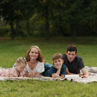 Photo of a family on a picnic blanket